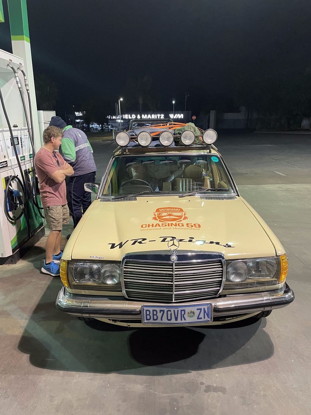 The Mercedes-Benz with the CHASING 59 bonnet decal at a fuel stop at night, SA Bull Run, October 2025