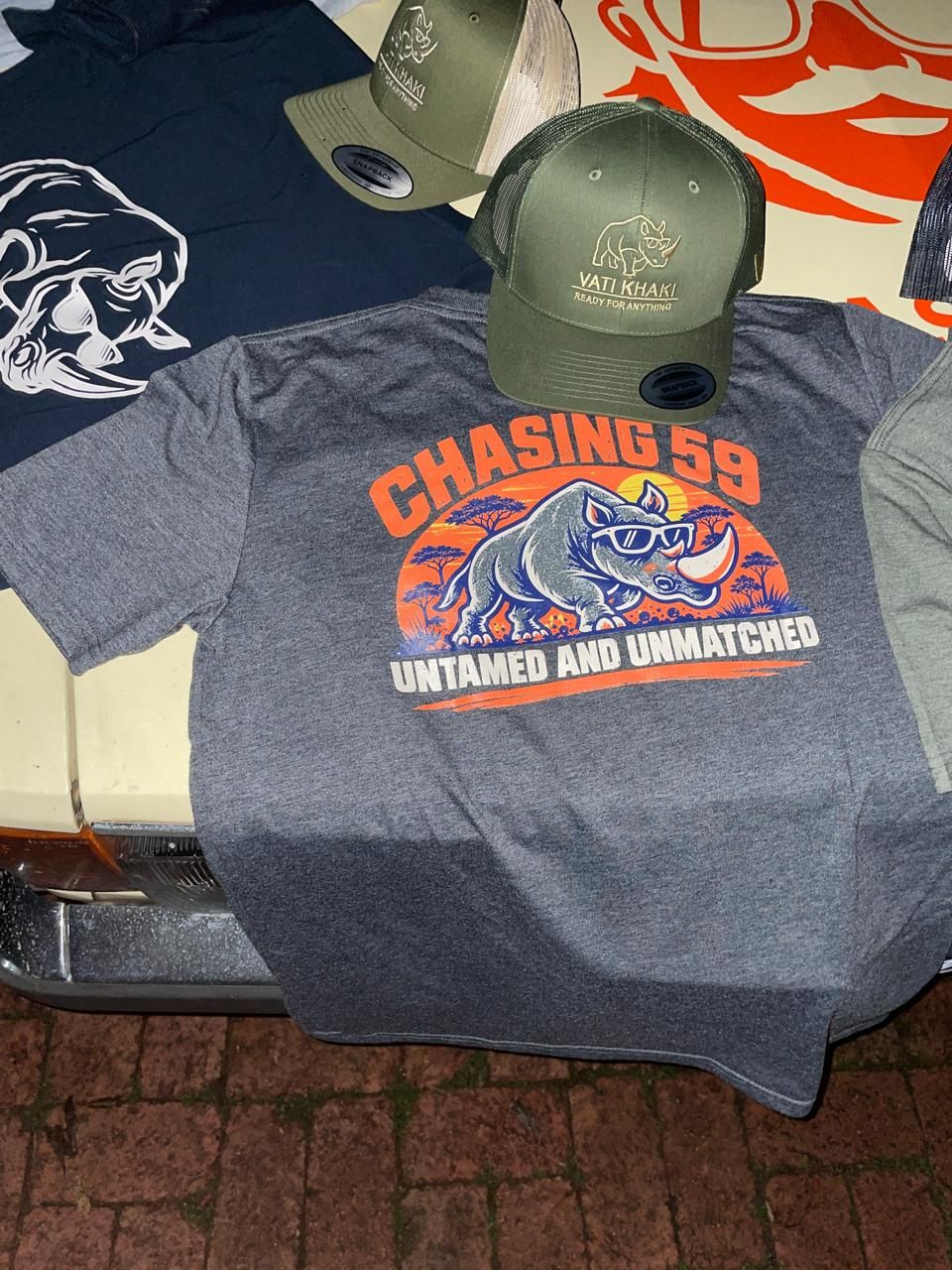 The charcoal CHASING 59 Untamed and Unmatched rhino tee, photographed before Bull Run 2026